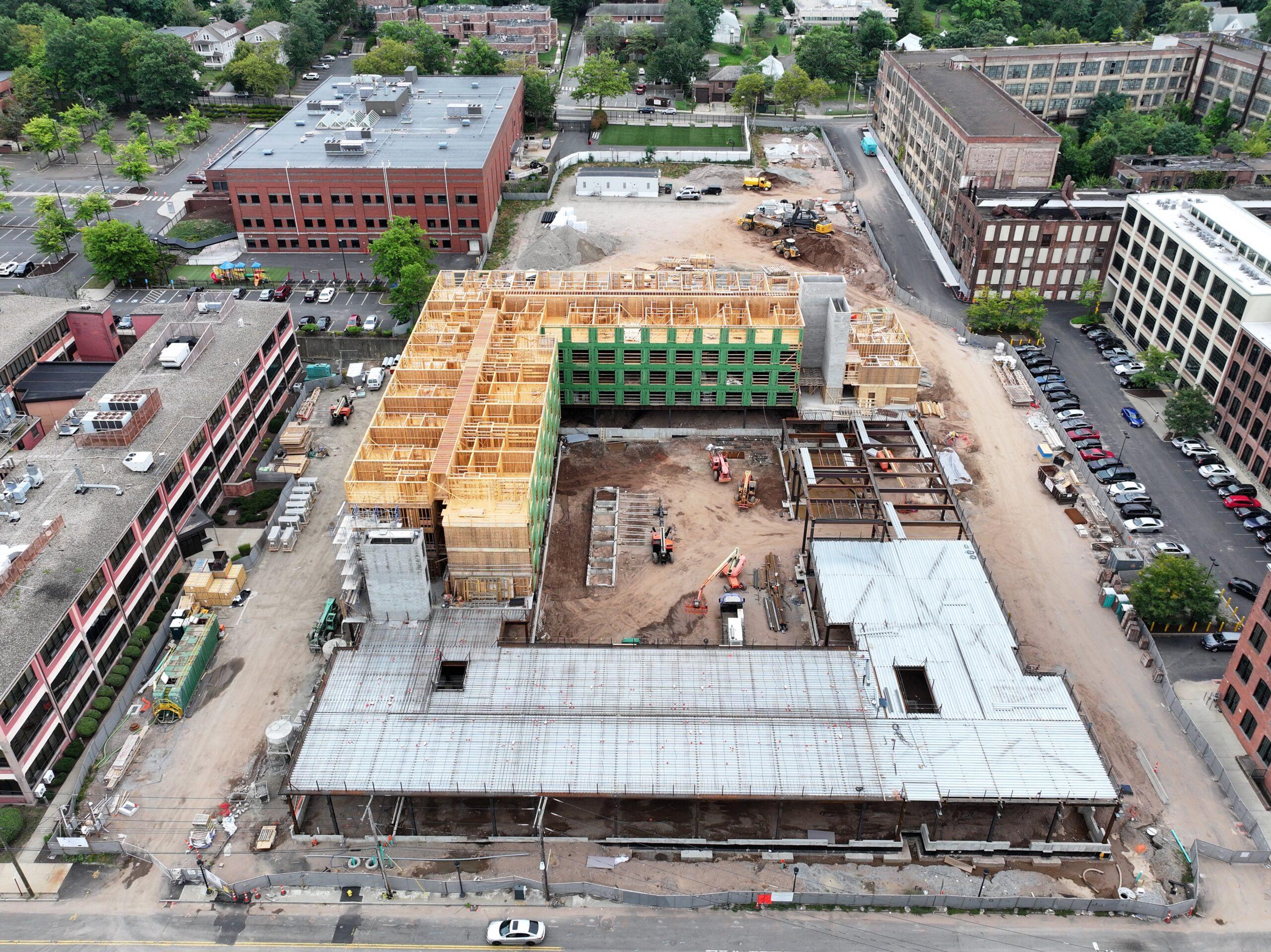 Aerial view of The Winston construction site Aerial view of an apartment building under construction, with wood framing rising above a concrete podium
