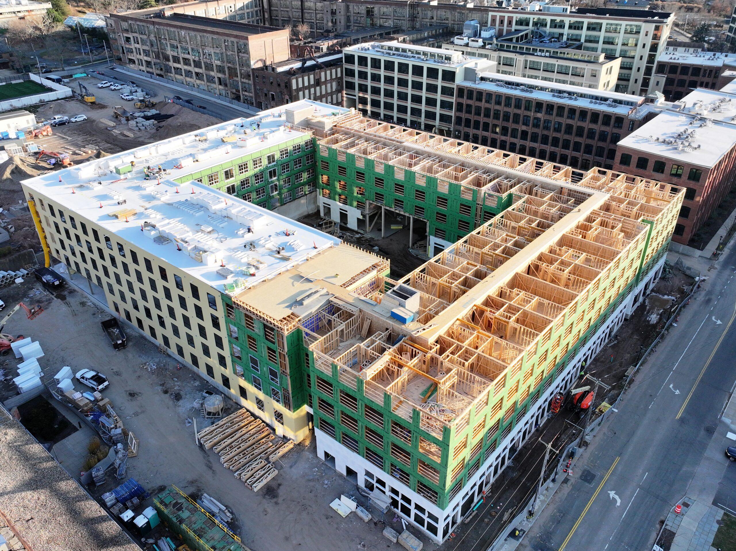 Aerial view of The Winston construction site Aerial view of a wood-framed apartment building under construction around a central courtyard