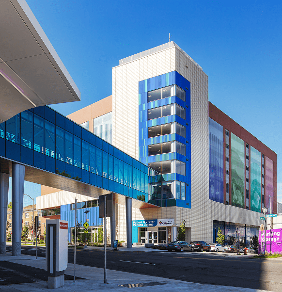 Exterior of a modern building with a blue glass skybridge
