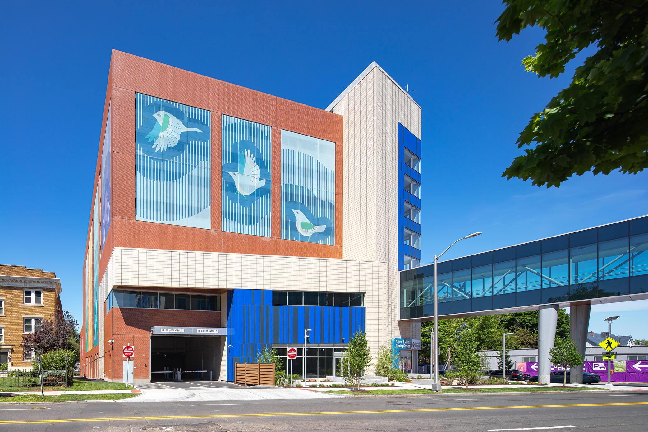 LPRI CCMC Garage Mural Facade of the LPRI CCMC garage featuring a large bird mural on red panels beside blue glass